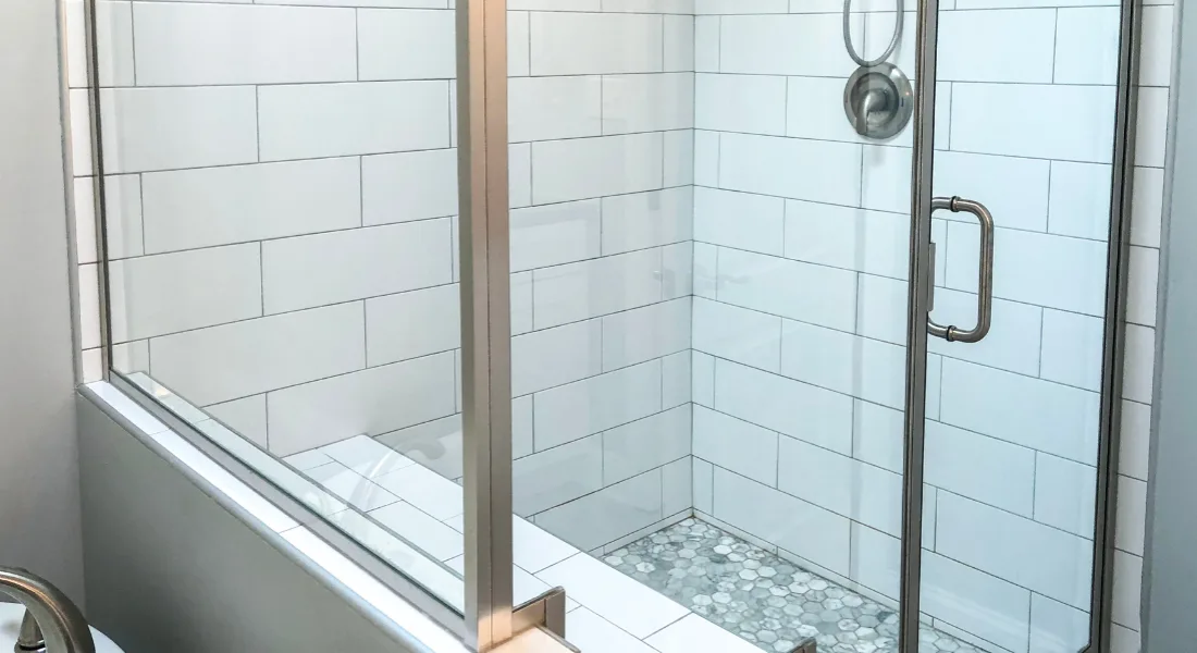 Modern glass shower enclosure in a renovated bathroom
