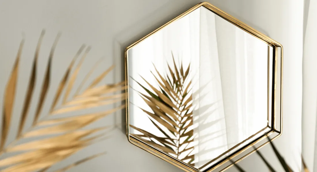 Collection of decorative odd-shaped mirrors on a wall