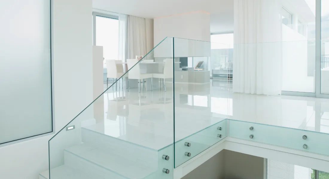 Glass stair railing with frameless panels on modern staircase