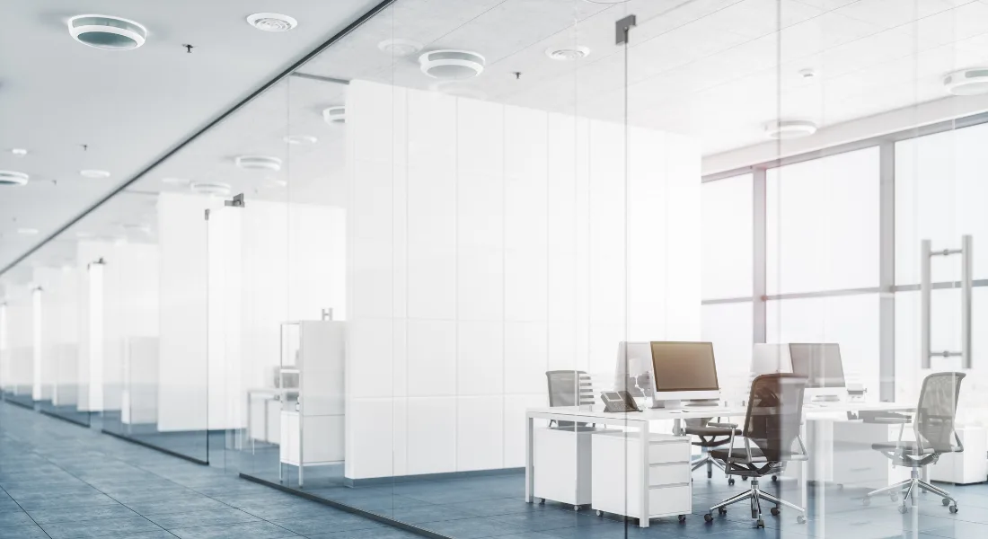Glass office partitions creating private workspace in open office