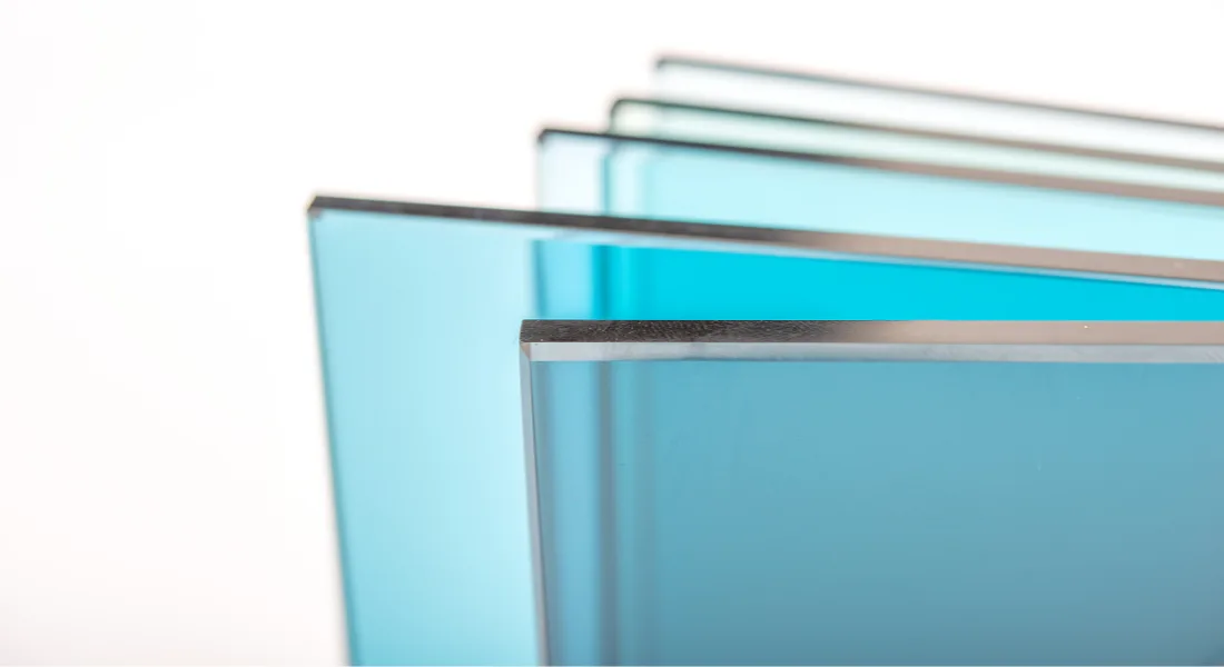 Glass cutter scoring a pane of custom glass