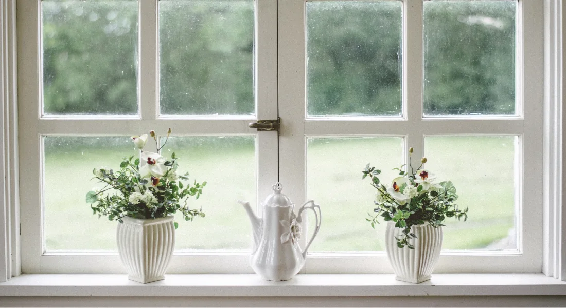 Different window frame material samples showing vinyl, wood, and aluminum