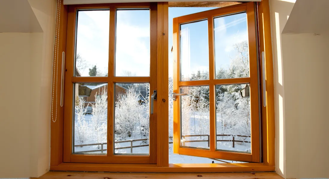 Wood frame double-hung window being maintained